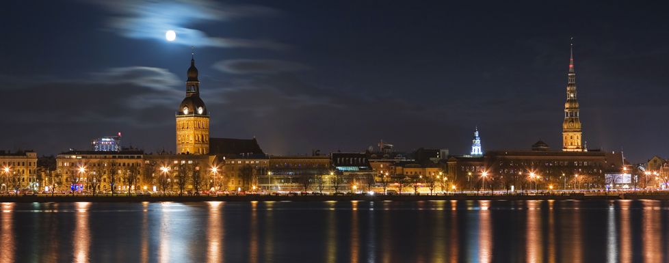 Daugava River waterfront illuminated at night