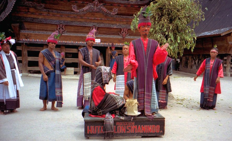 Stone chairs and statue at Ambarita Village on Pulau Samosir in Lake Toba, Sumatra